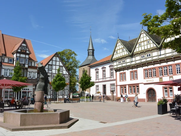 Historisches Rathaus von Blomberg mit Fachwerkfassaden und einem Brunnen im belebten Stadtzentrum.