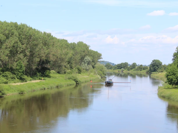 The Aalschokker on the Weser near Landesbergen is picturesquely situated between dense greenery on the banks of the river.