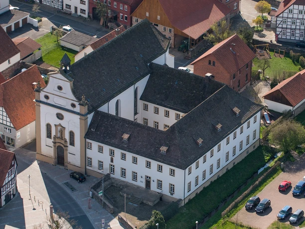 Luftaufnahme des historischen Franziskanerklosters in Lügde, umgeben von Fachwerkhäusern.
