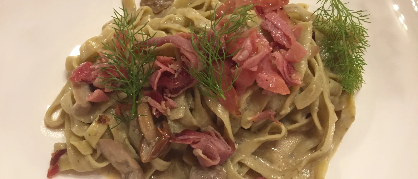 Tagliatelle with cream sauce, mushrooms, ham and dill. A delicious Italian pasta dish.