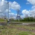 Bahnhof Leese-Stolzenau vor blühenden Bäumen und blauem Himmel; ruhig gelegen mit Bahnsteigzugang.