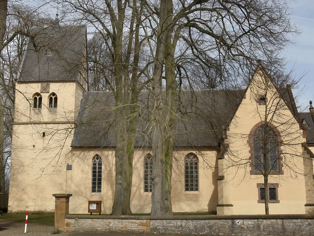 Marienkirche Wallenbrück Die Marienkirche Wallenbrück ist eine historische Kirche mit Glockenturm, umgeben von hohen Bäumen.