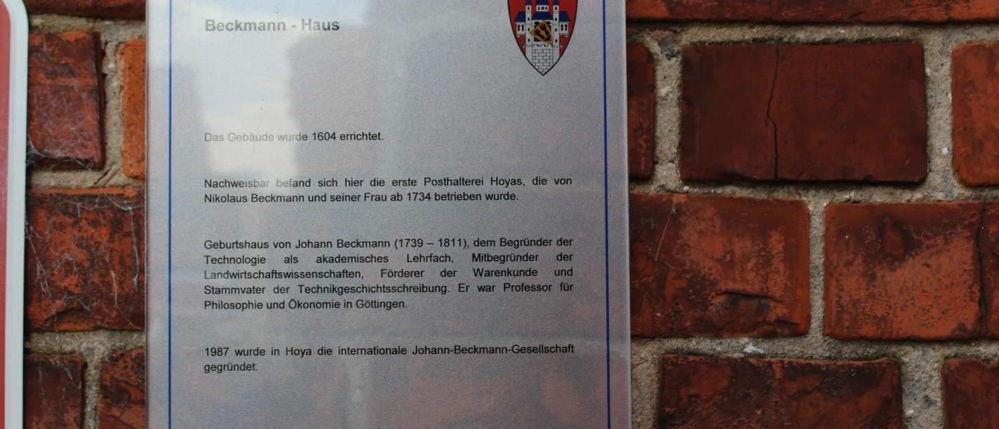 Beckmann Haus Commemorative plaque on a brick wall providing information about the historic Beckmann House from 1504.