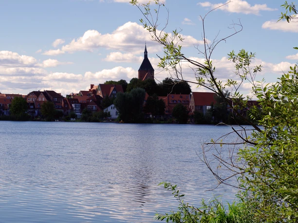 Über den Schulsee hinweg ist die Altstadt von Mölln zu sehen.