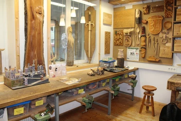 KreativWerkstatt am Wall Holzwerkstatt mit Werkbank, Werkzeugen und hölzernen Kunstwerken an den Wänden, inklusive Modellbau.