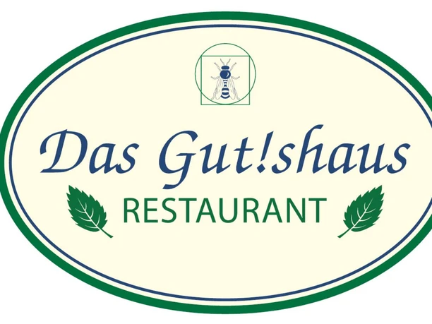 Ovale Logografik des Restaurants „Das Gut!shaus“ mit stilisiertem Insekt und grünen Blättern.