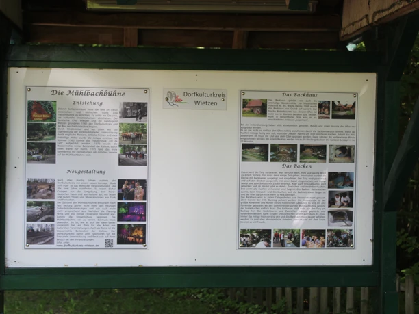 Information sign in a green space with explanations about the history and cultural offerings of the village of Wietzen.