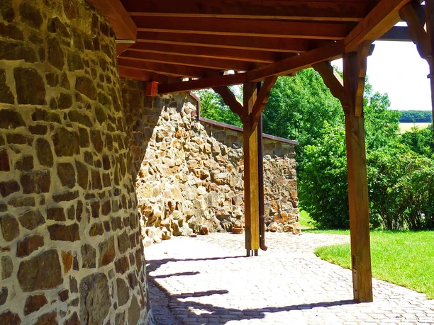 Windmühle Vlotho-Exter Man steht neben der Windmühle unter dem Dach und sieht die Balken der Überdachung