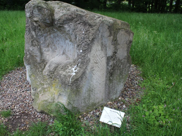 A stone sculpture in Etelsen Park depicts a person who appears to be harnessed to a cart.