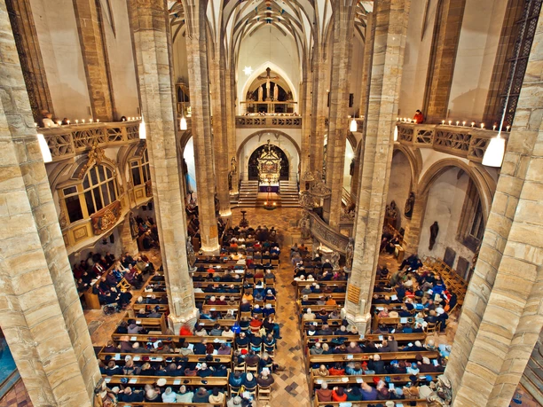 Interior view of the cathedral in Freiberg with many visitors during an event.