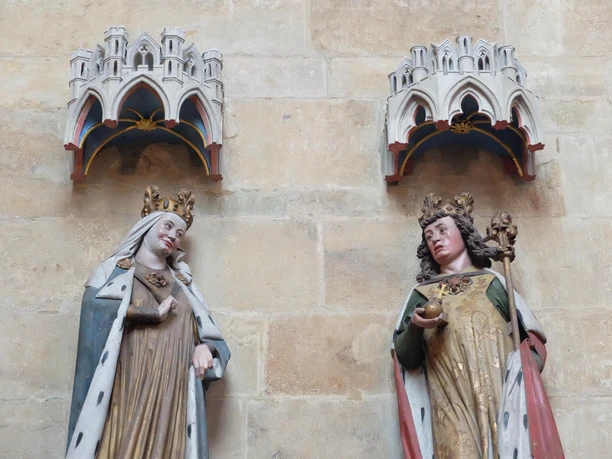 Two colorful sculptures of donors in Meissen Cathedral with detailed crowns.