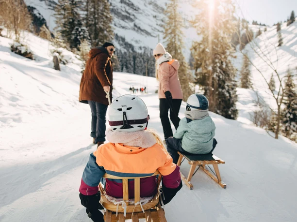 Sledging on the Wiriehorn for the whole family Parents pull the children sitting on the sled