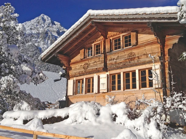 Wooden chalet in a winter mountain landscape