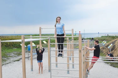 Thalasso-Bewegungsparcours.jpg Mehrere sportlich gekleidete Personen machen Sport auf dem Outdoor-Bewegungsparcours vor der Nordsee.
