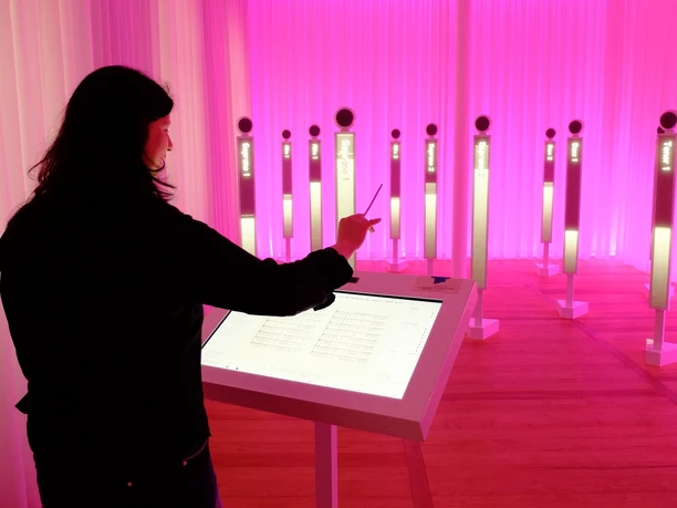 Visitors experience interactive exhibition about music with luminous sound installations.