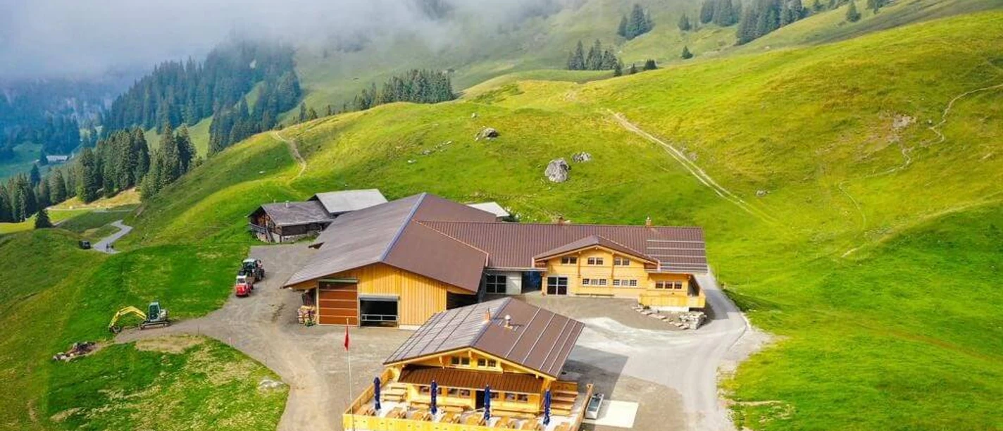 Seeberg Restaurant from above Spacious alpine buildings surrounded by green alpine meadows