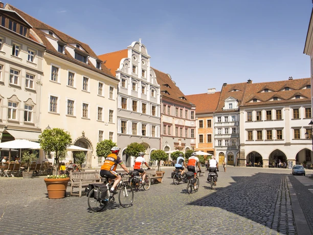 Cyclists explore Görlitz's historic market square with its carefully restored facades.