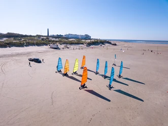 DJI_0051.jpg Bunte Strandsegel fahren über den hellen Sandstrand.