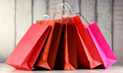 Composition with red paper shopping bags