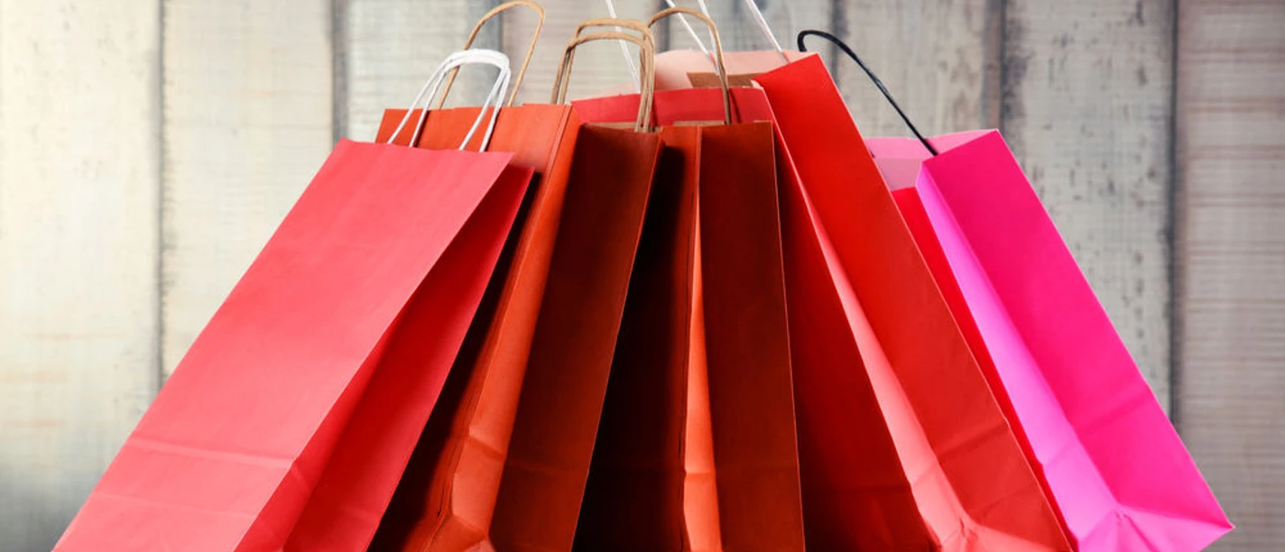 Composition with red paper shopping bags