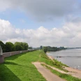 Deich Monheim am Rhein Grüner Deichabschnitt entlang des Rheins in Monheim, gesäumt von Wegen und ankernden Booten einstellen.