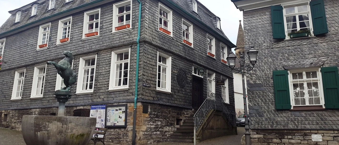 Außenansicht Alte Bürgermeisterei und Stadtgeschichtshaus Mettmann Alte Bürgermeisterei und Stadtgeschichtshaus Mettmann mit Statue und Infotafel im Vordergrund.