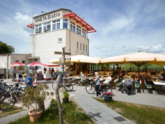 View of the VINETA bistro and its outdoor seating area on Lake Stoermthal in the Neuseenland region of Leipzig