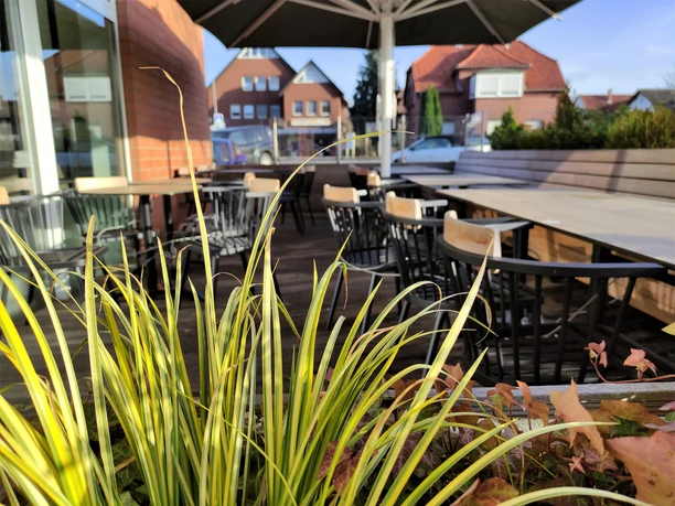 Terrasse Café novocento Vlotho Blick durch die Blume auf den Außenbereich des Cafés