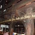 Tenne.jpg Holzvertäfelte Bar mit traditionellem Schriftzug und historischen Balken; darunter gemütlicher Tresen.