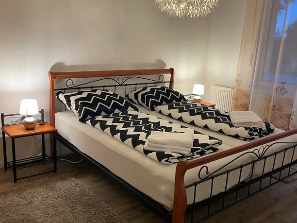 Fewo Julia Betten.jpg Zwei zusammengestellte Einzelbetten mit geometrisch gemusterten Decken in einem modern eingerichteten Raum.