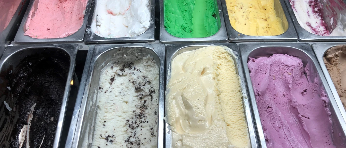 Various ice cream flavors in one counter, from strawberry and pistachio to chocolate and lemon.