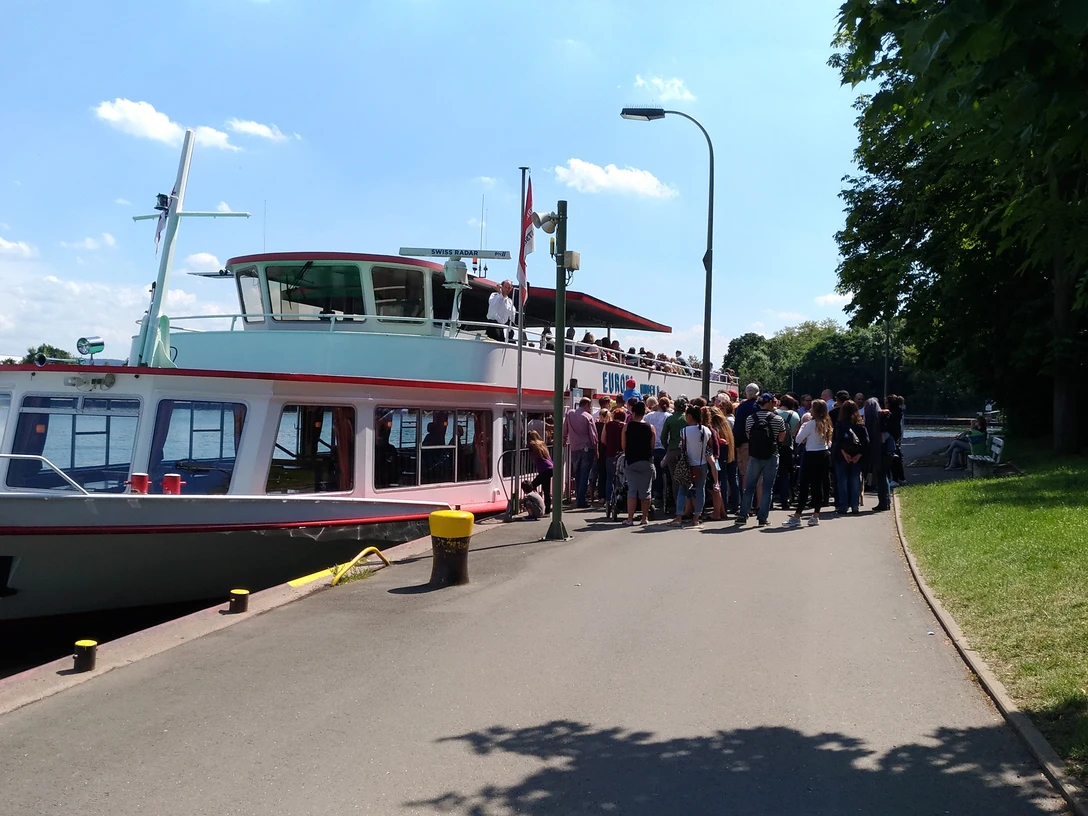 Das Bild zeigt den Anleger, an dem ein Schiff der Mindener Fahrgastschiffe liegt und Gäste einsteigen.