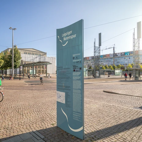 Sunny day on Augustusplatz with a view of the opera, in the foreground you can see a stele of the Notenspur, city of music, culture