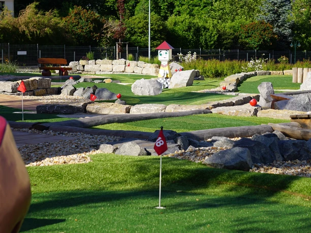 View of the mini-golf course at the adventure golf park in Groitzsch, with the Bieraterie bistro in the background, leisure, family, mini-golf, gastronomy, Leipzig with children