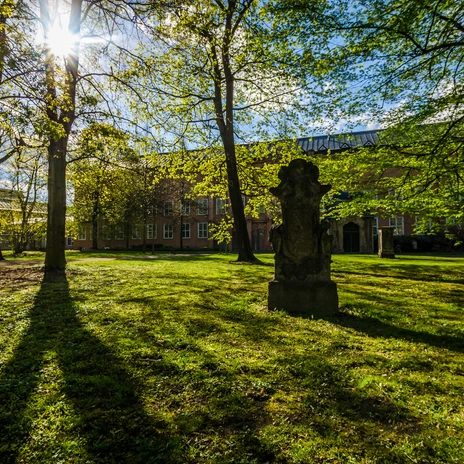 Alter Johannisfriedhof - Cultural institutions in Leipzig View over the meadow and the planting of the Johannisfriedhof cemetery and the brick buildings in the background