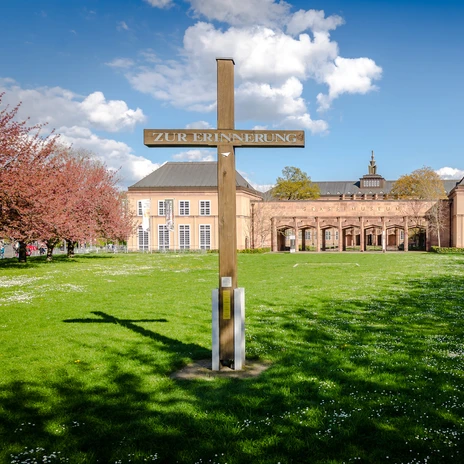 Widok na drewniany krzyż upamiętniający zniszczony kościół św. Jana i budynek Muzeum Etnologii, Instrumentów Muzycznych i Sztuki Użytkowej Grassi na Johannisplatz, gdzie można zobaczyć wspaniałe wystawy, instytucja kultury w Lipsku, muzeum, historia, kultura