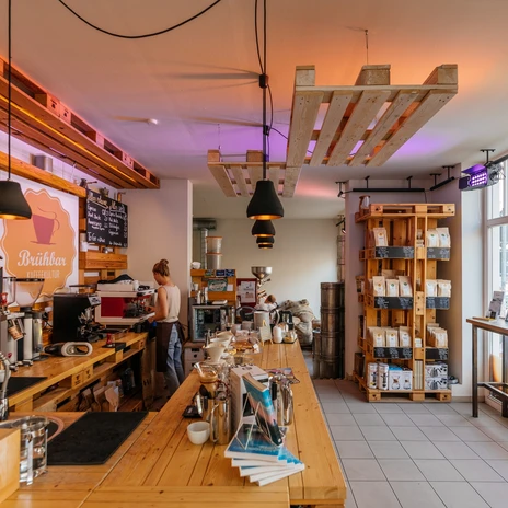 Vue de l'élégant et confortable Brübar, de son comptoir, des étagères, de la baie vitrée et de la zone d'accueil, café, plaisir, café