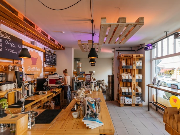 View of the stylish and cozy Brübar, its counter, shelves, window front and reception area, café, indulgence, coffee