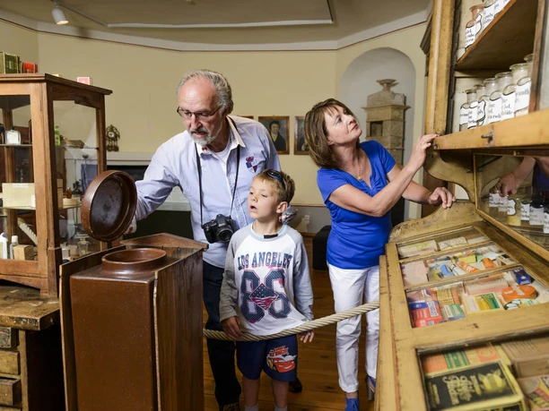 A family with a child looks around inside Düben Castle in the Landscape Museum, Leipzig with children, museum, excursion