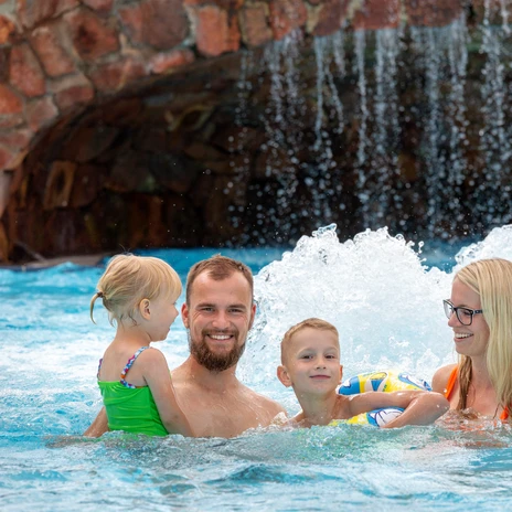 Eine glückliche Familie in einem sprudelnden Schwimmbecken des Freizeitbades Riff in Bad Lausick