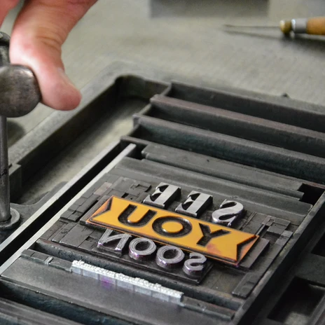 A printing plate is clamped and prepared for printing in the Museum of Printing Arts during the Year of Industrial Culture, History
