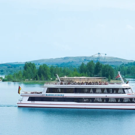 The MS Markkleeberg of the passenger boat service in Leipzig's New Lake District sails with guests on board on Lake Markkleeberg, the Mining Technology Park can be seen in the background, excursion, leisure activity