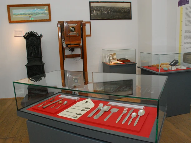 The permanent exhibition in the Döbeln City Museum displays historical everyday objects in glass cabinets.