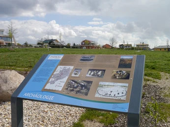 Geologischer Lehrpfad am Zwenkauer See Eine Informationstafel am Zwenkauer See zeigt archäologische Fundstücke in einer ländlichen Landschaft.