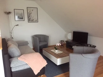 fewo_moennekes_wohnzimmer.jpg Wohnbereich mit Sofa, zwei Sesseln und TV