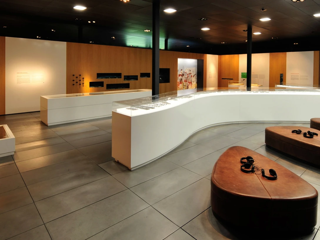 Ausstellung im Museum der BARUSSCHLACHT Moderne Museumsausstellung mit informativem Wandpanel, Glasvitrinen und bequemen Sitzgelegenheiten.Modern museum exhibition with informative wall panel, glass showcases and comfortable seating.Moderne museumsudstilling med informative vægpaneler, glasmontrer og behagelige siddepladser.Moderne museumtentoonstelling met informatieve wandpanelen, glazen vitrines en comfortabele zitplaatsen.