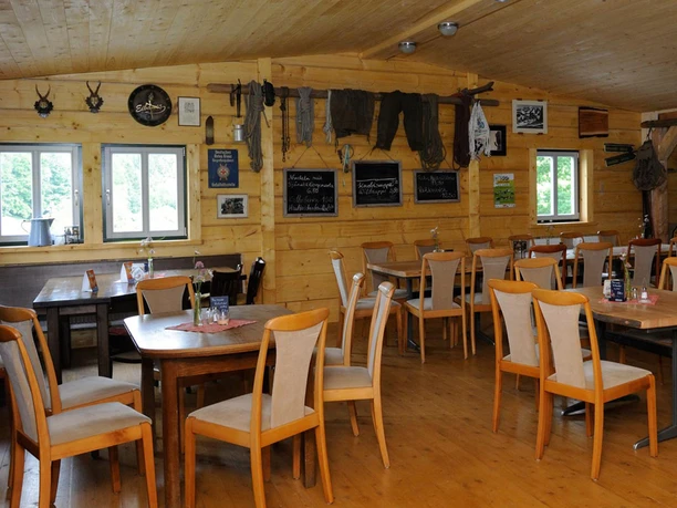 Wood-paneled guest room of the Ottendorfer Hütte with rustic furniture and cozy decoration.