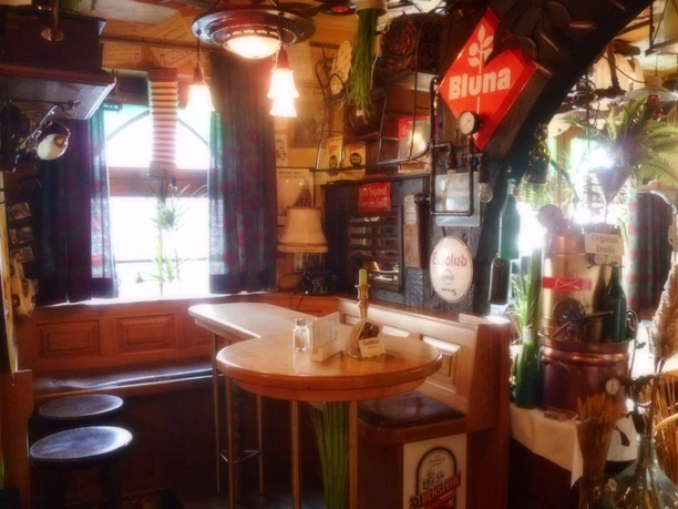 Ein gemütliches, rustikales Café-Interieur mit hölzernen Möbeln und nostalgischer Dekoration.