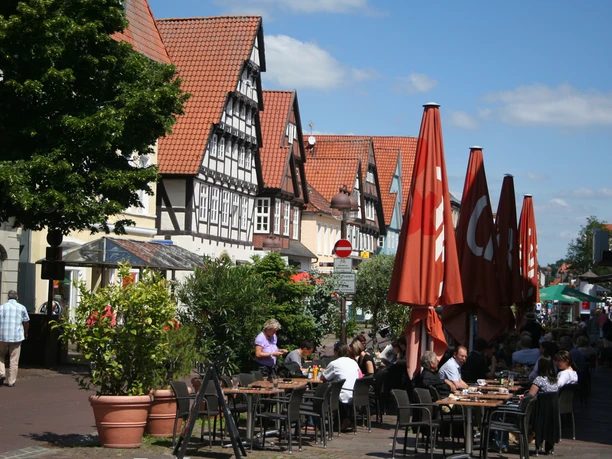 Altstadt Nienburg Lange Straße People enjoy a sunny day in a café on the historic half-timbered street in Nienburg.