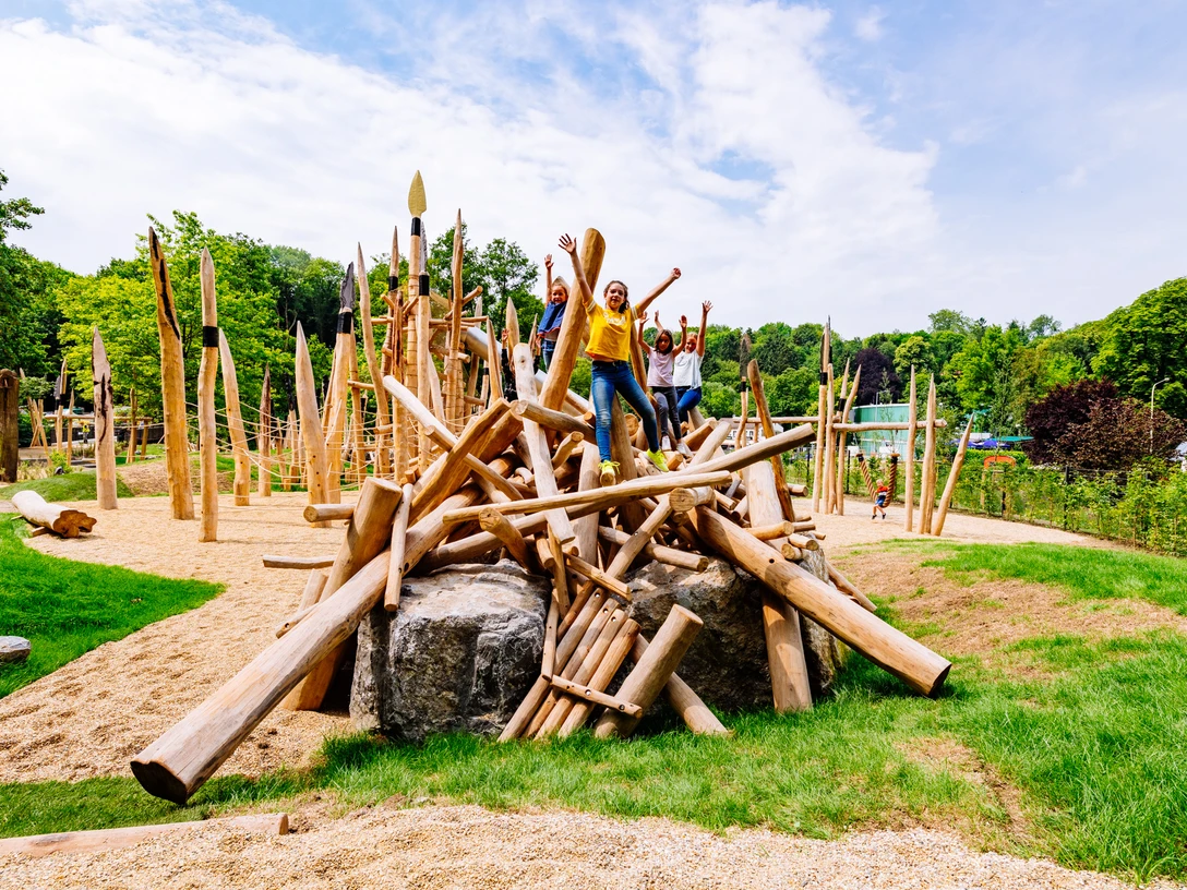 Stone Age playground at the Neanderthal Museum in Mettmann Children play on an outdoor adventure playground made of wooden logs.